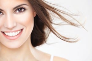 Beauty portrait of a young brunette woman with beautiful smile